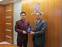 Prof. Henry Wong (right), Former Chairperson of Research Committee presents a souvenir to Mr. Lei Biao (left), head of the Zhongshan Municipal Party Organization